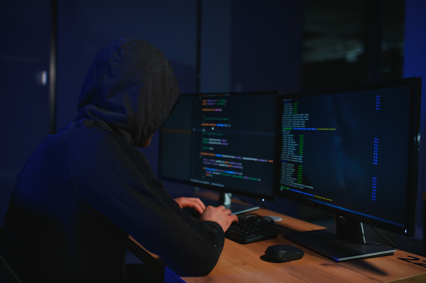 Hacker installing malicious software on data center servers representing the danger of exposed public records