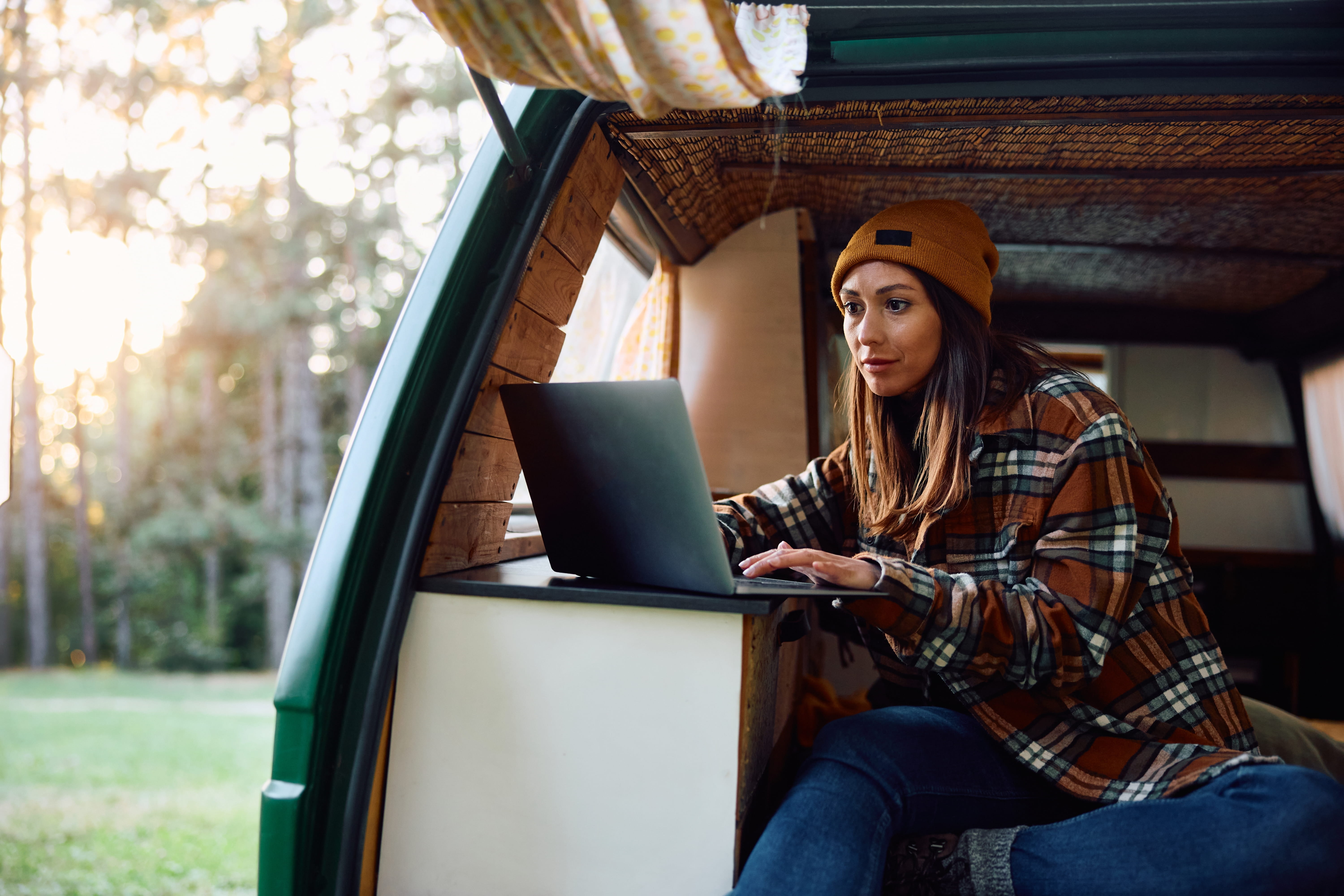 Young woman using a laptop computer to view and manage her digital mailbox inventory